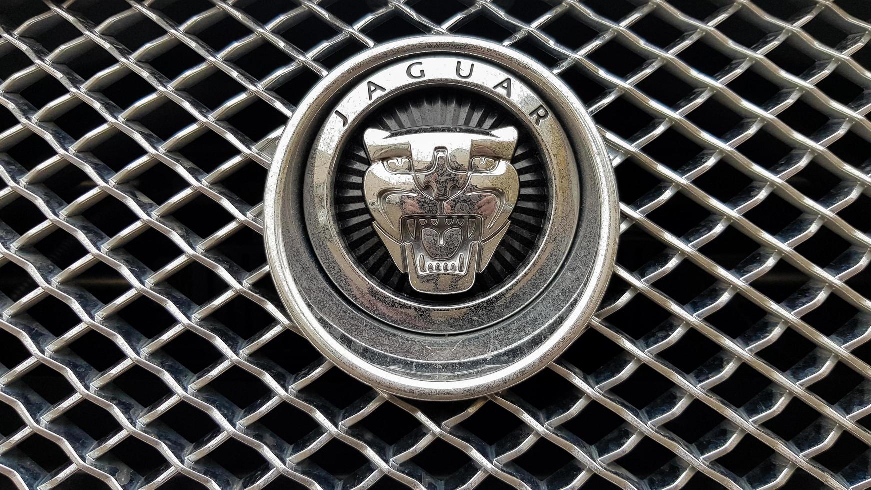 Ukraine, Kiev - March 27, 2020. Close-up view of the Jaguar logo on a new car radiator grill. Founded in 1922, the British multinational luxury car manufacturer headquartered in Coventry, England. photo