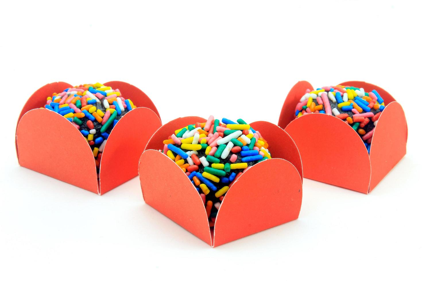 brigadeiro, brigadier, sweet chocolate typical of Brazilian cuisine covered with particles, in a wooden background. photo