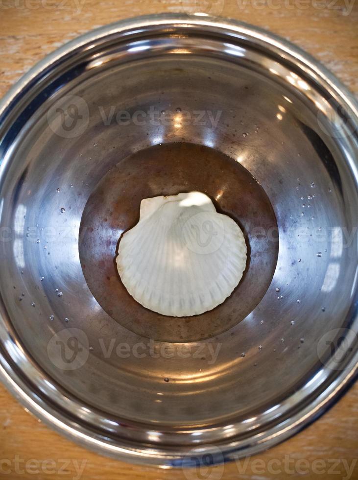 Close-up of an opened Baptismal with water and Shell in a church photo