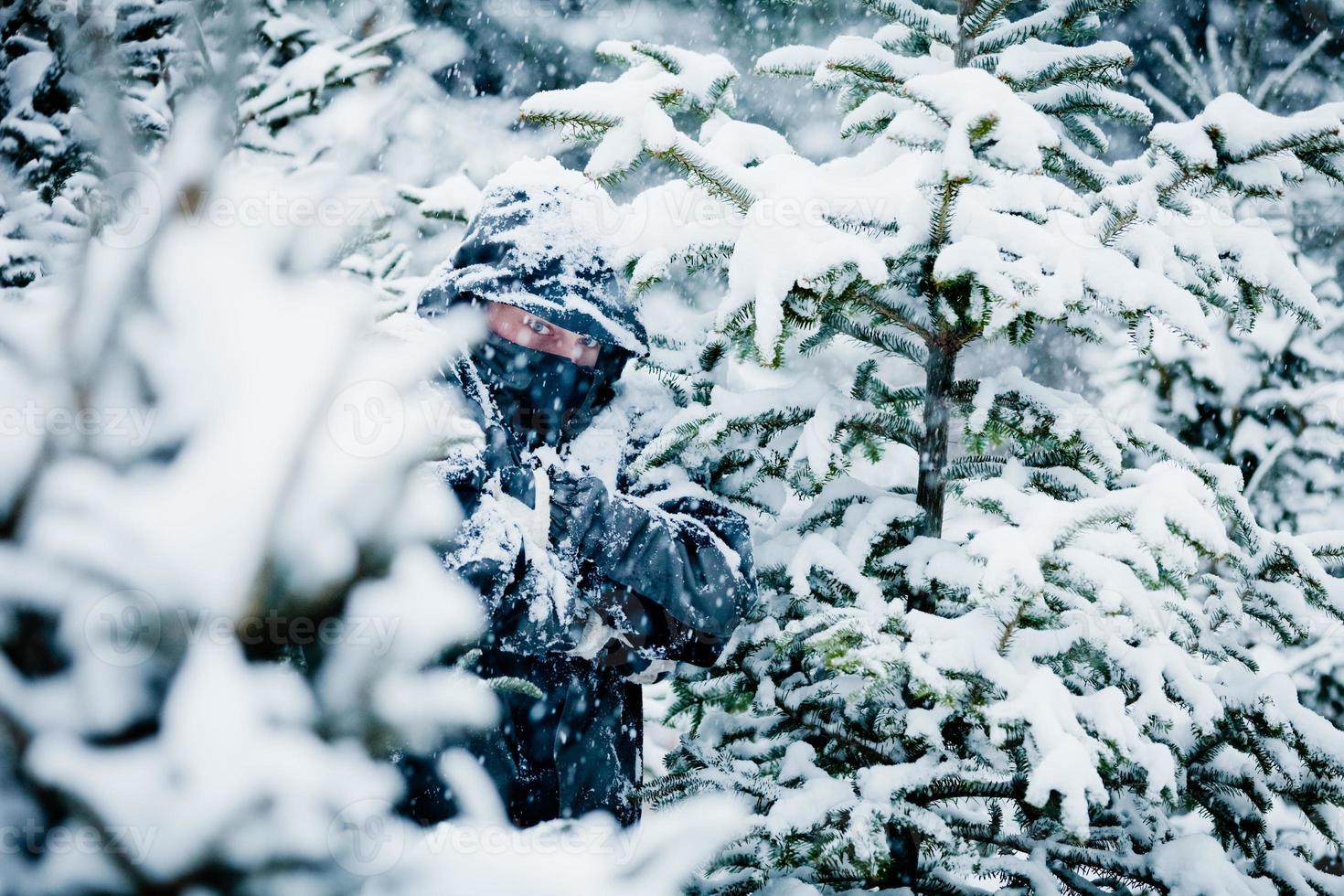 Man Hiding Behind Trees in Forest photo