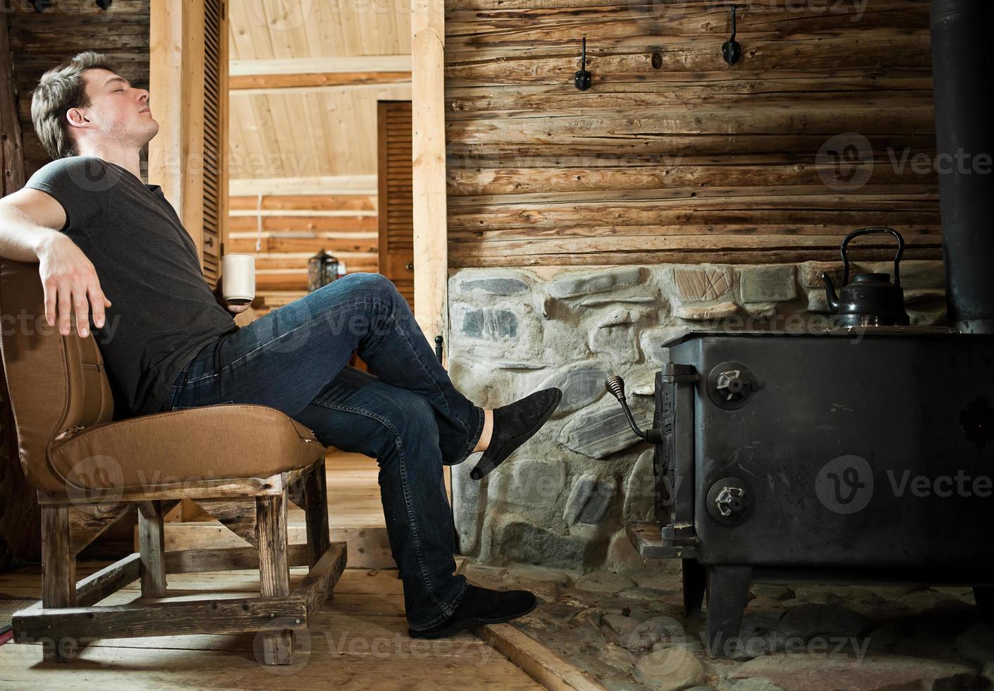 Lonely Man Relaxing with Slippers and Cup of Coffee. photo