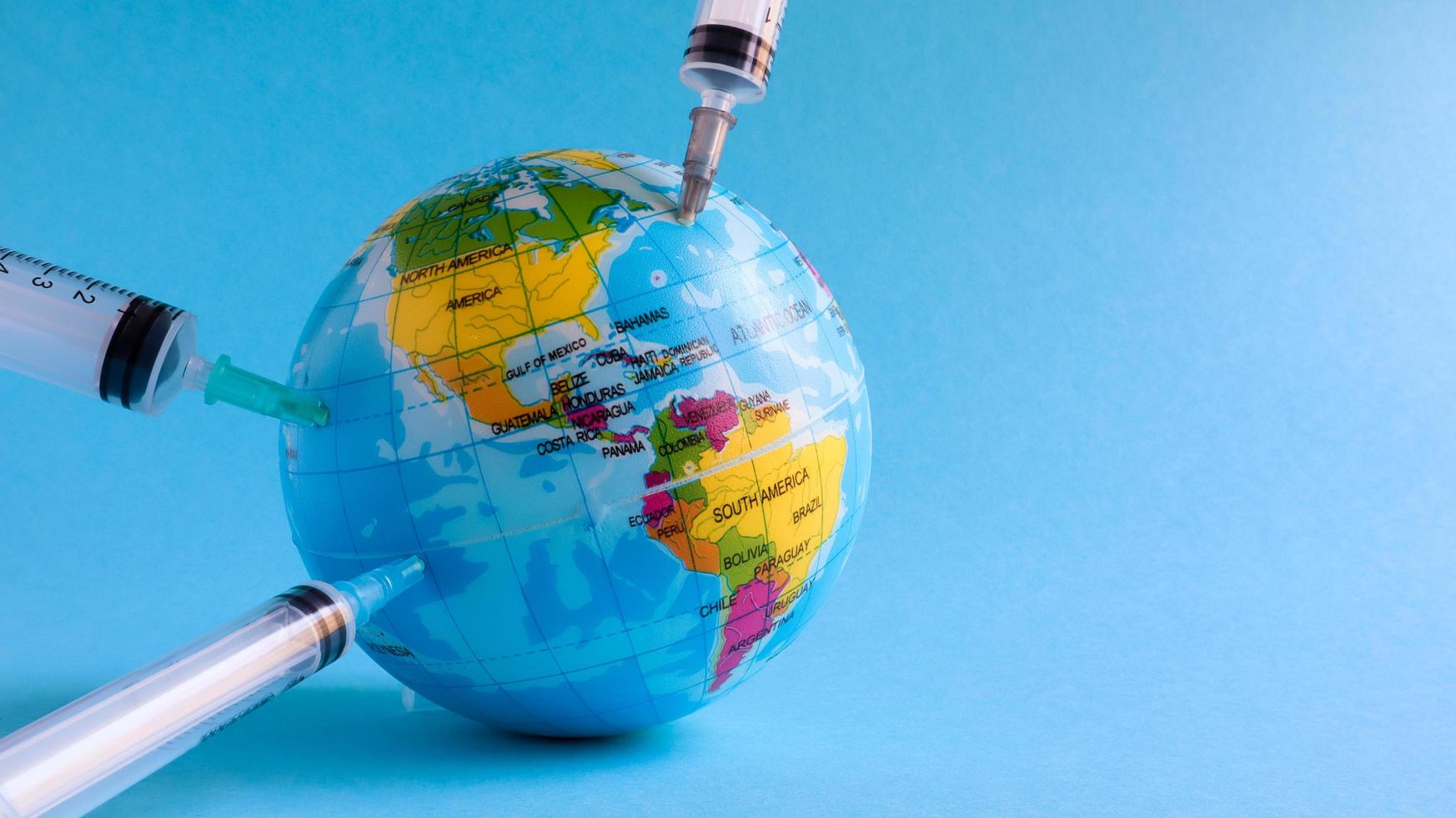 Ukraine, Kiev - April 15, 2020. Globe from the side of America full of syringes. To illustrate the need for a vaccine to fight the global pandemic in the United States caused by the Covid-19 virus. photo