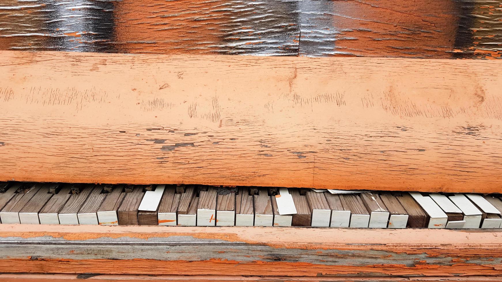 Closeup of a broken piano keyboard of an old piano. photo