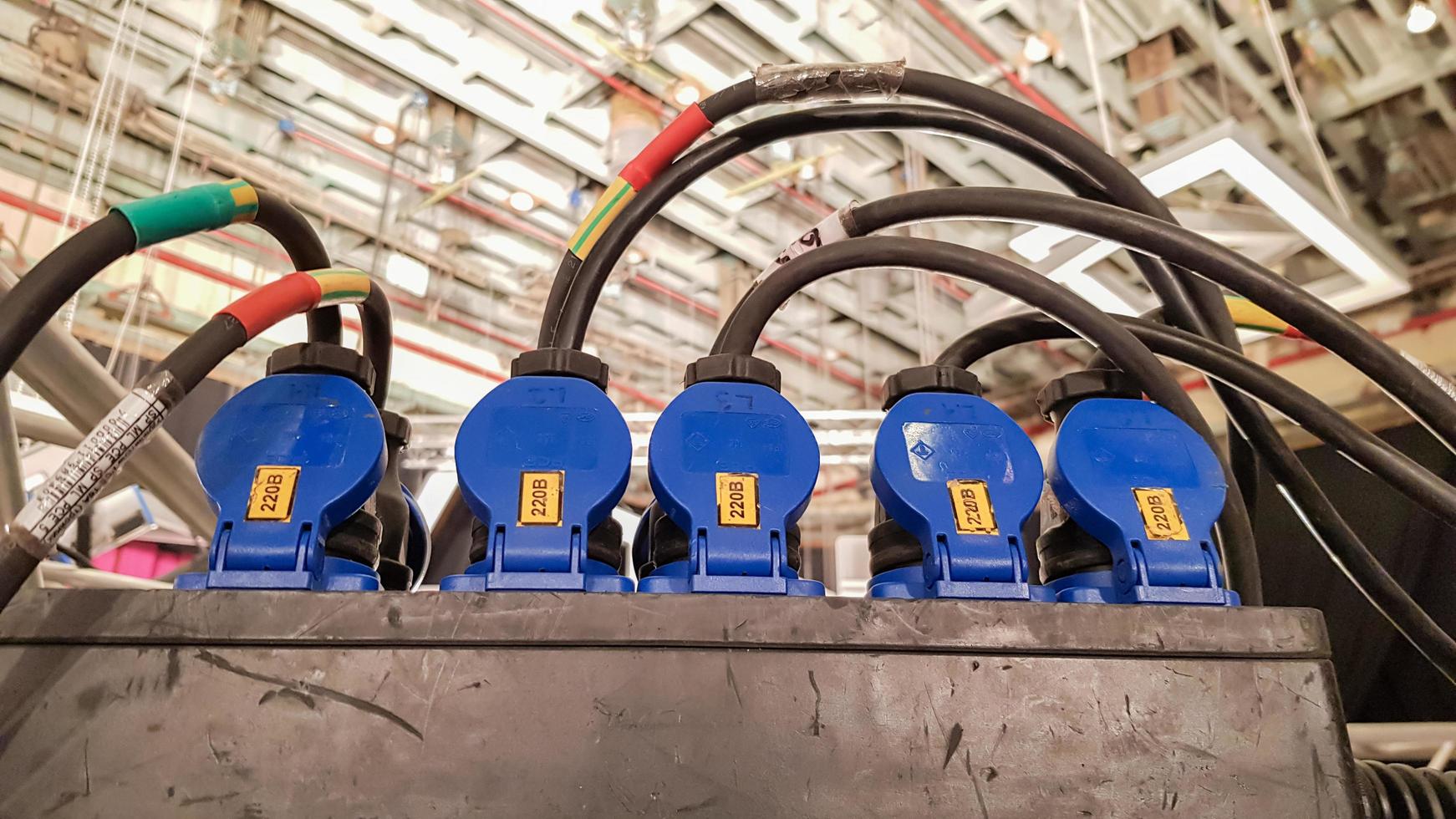 Plug in the power cord, many outlets with black plugs plugged in close up. Electricity in production. photo