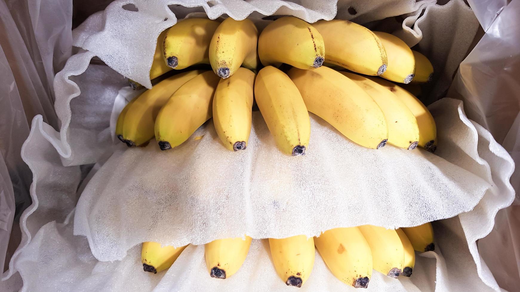Ripe bananas in a box in a store. At the display window. photo