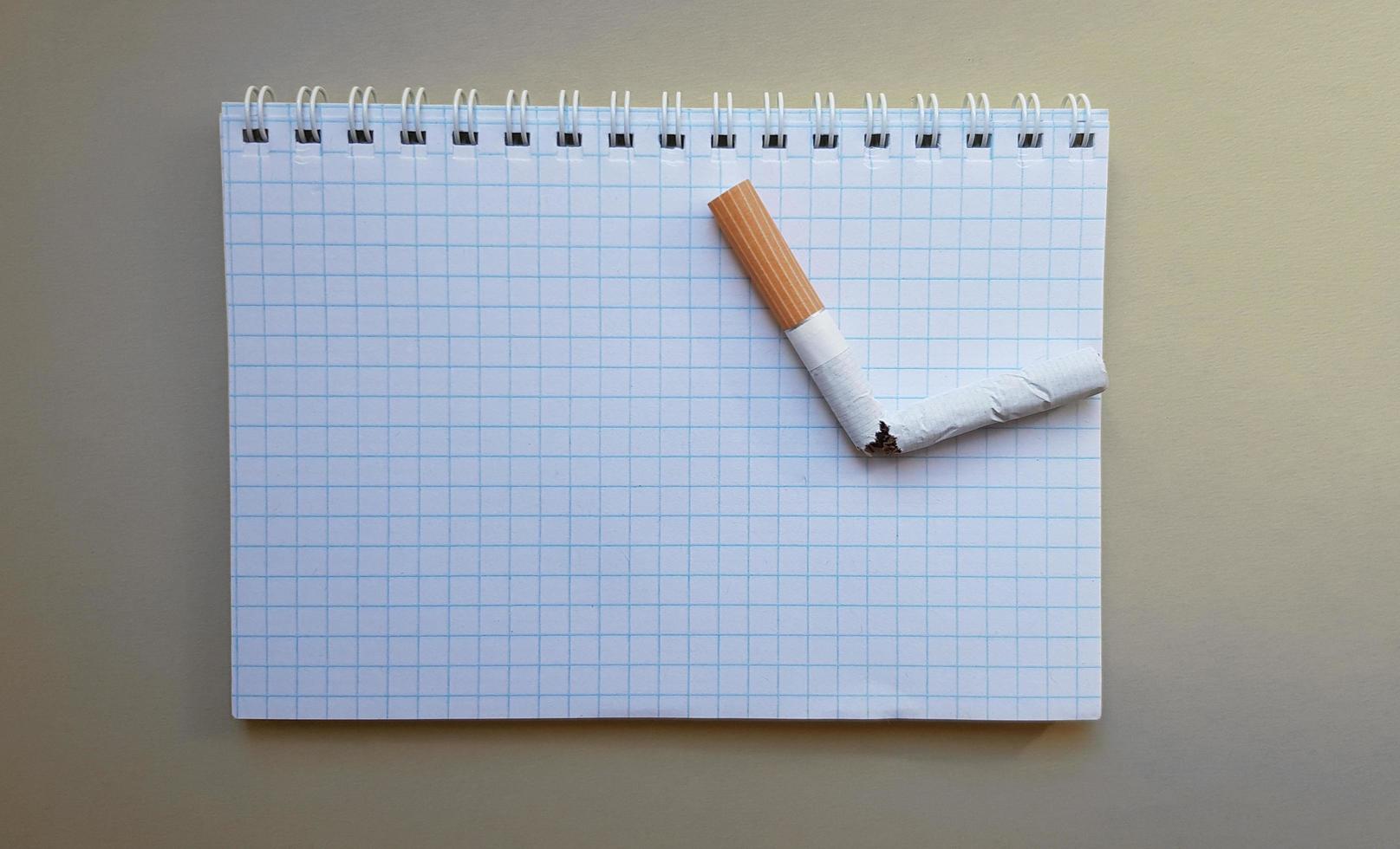 World No Tobacco Day, No Smoking Day. Broken cigarette on a business notebook, place for your text photo