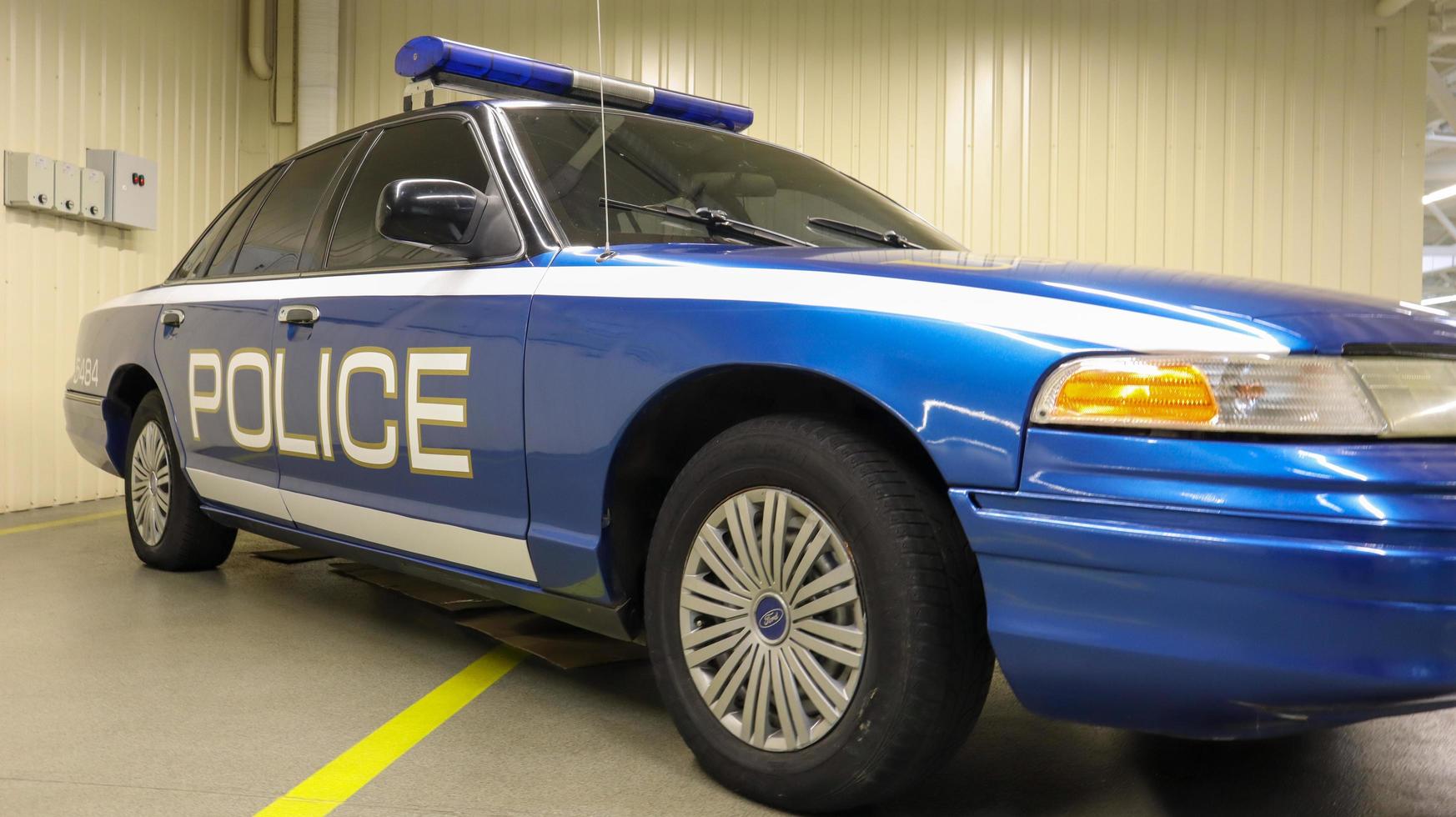 Police car Ford LTD Crown Victoria. Police car in blue with the word police in English. The passenger sedan was produced in 1991-2011. Ukraine, Kiev - June 09, 2021. photo