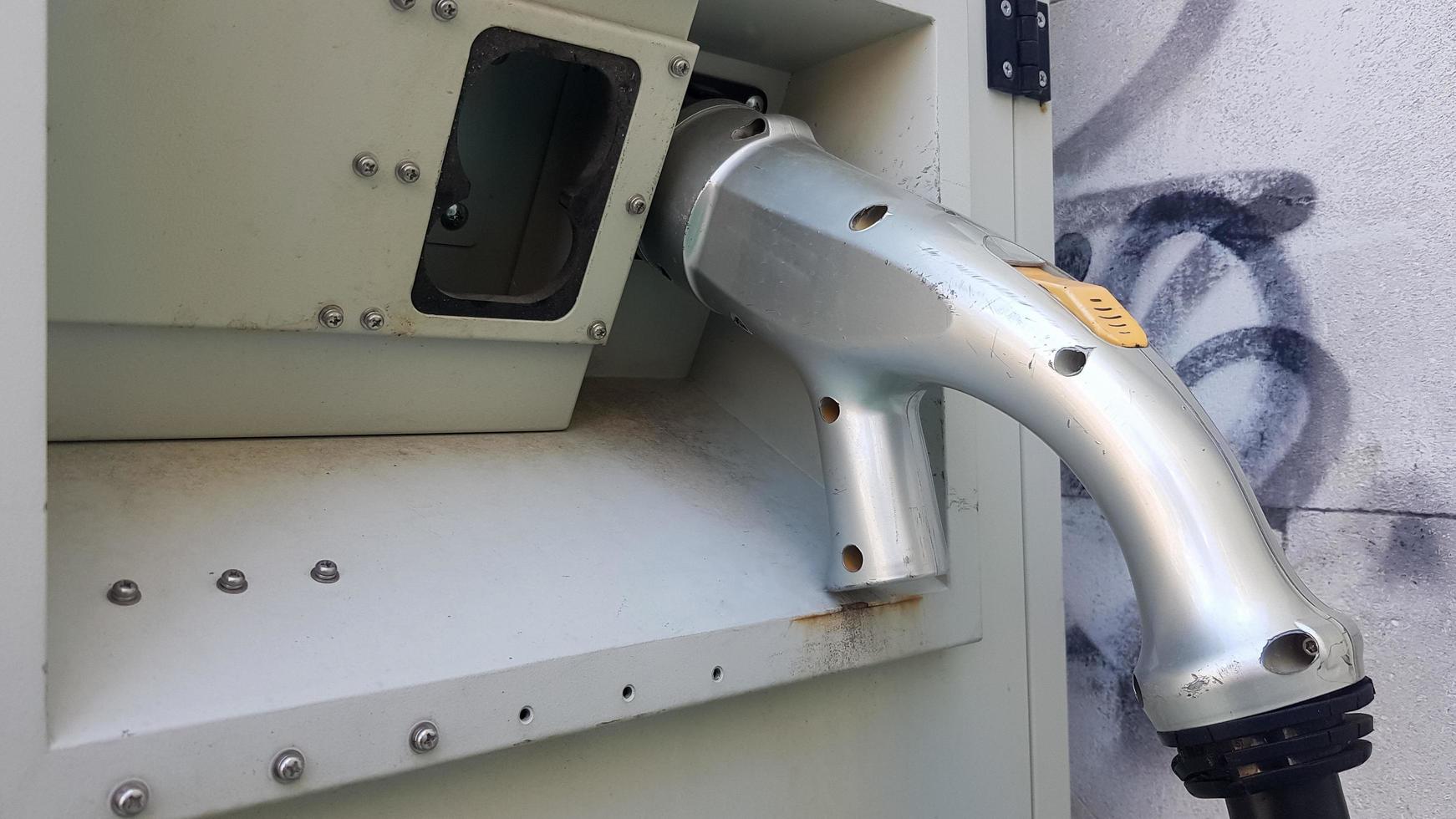 Power supply unit for charging an electric vehicle. Part of an old outdoor electric car charging station. Charger socket. photo