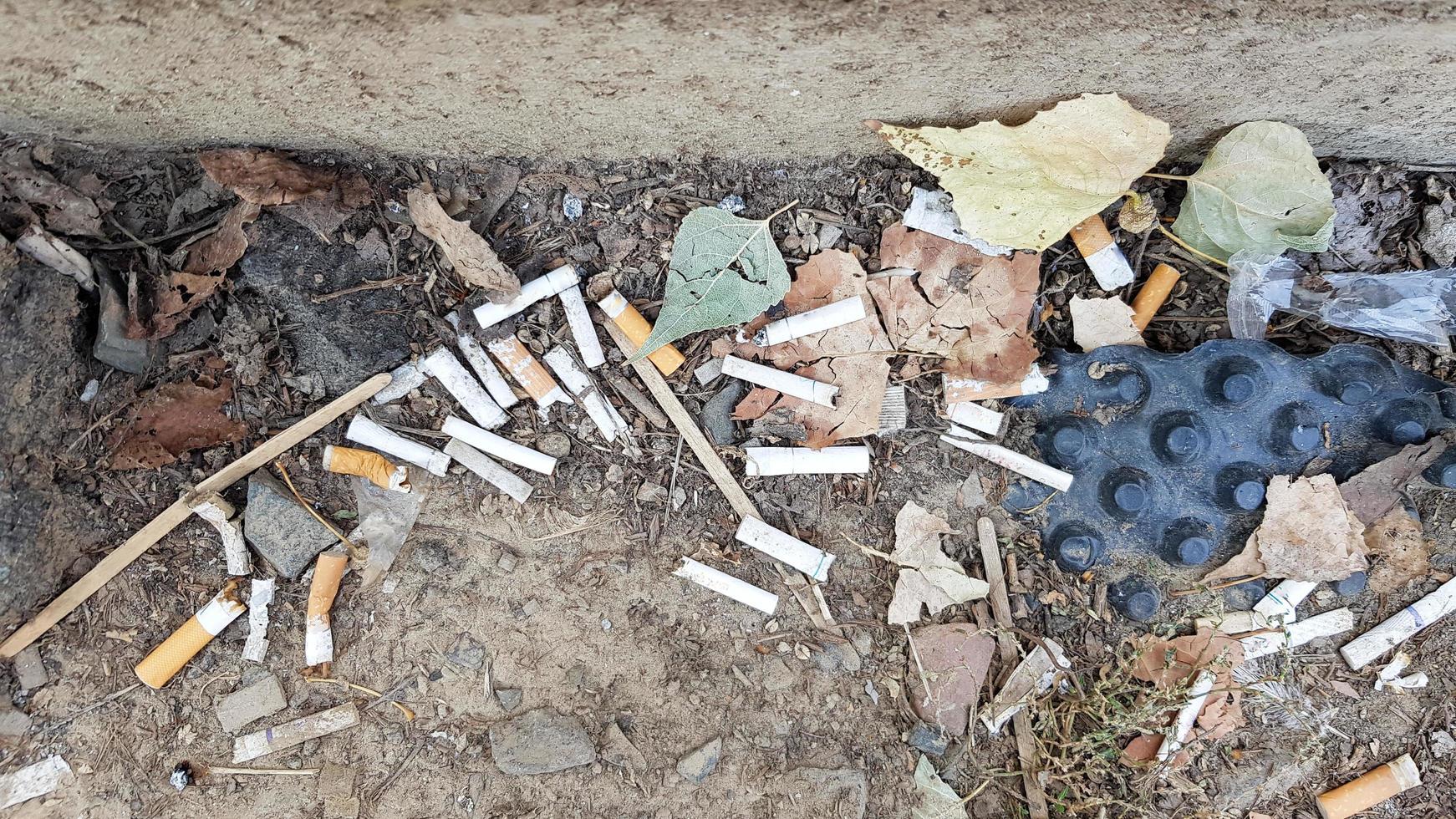 A lot of cigarette butts. The cause of lung cancer. Many used cigarette butts as trash photo