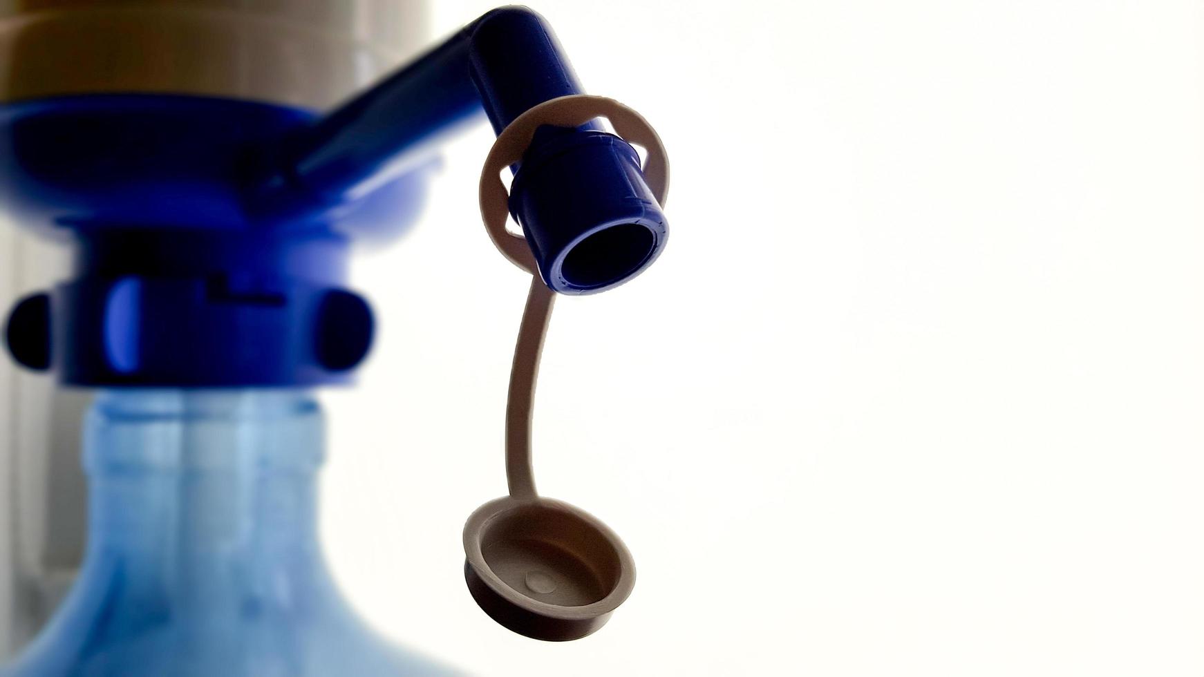 pump on a water bottle. Close-up on a white background photo