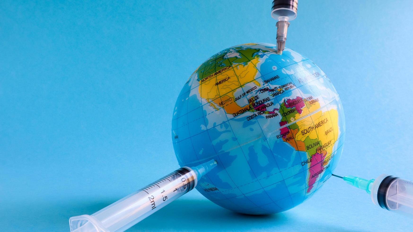 Ukraine, Kiev - April 15, 2020. Globe from the side of America full of syringes. To illustrate the need for a vaccine to fight the global pandemic in the United States caused by the Covid-19 virus. photo