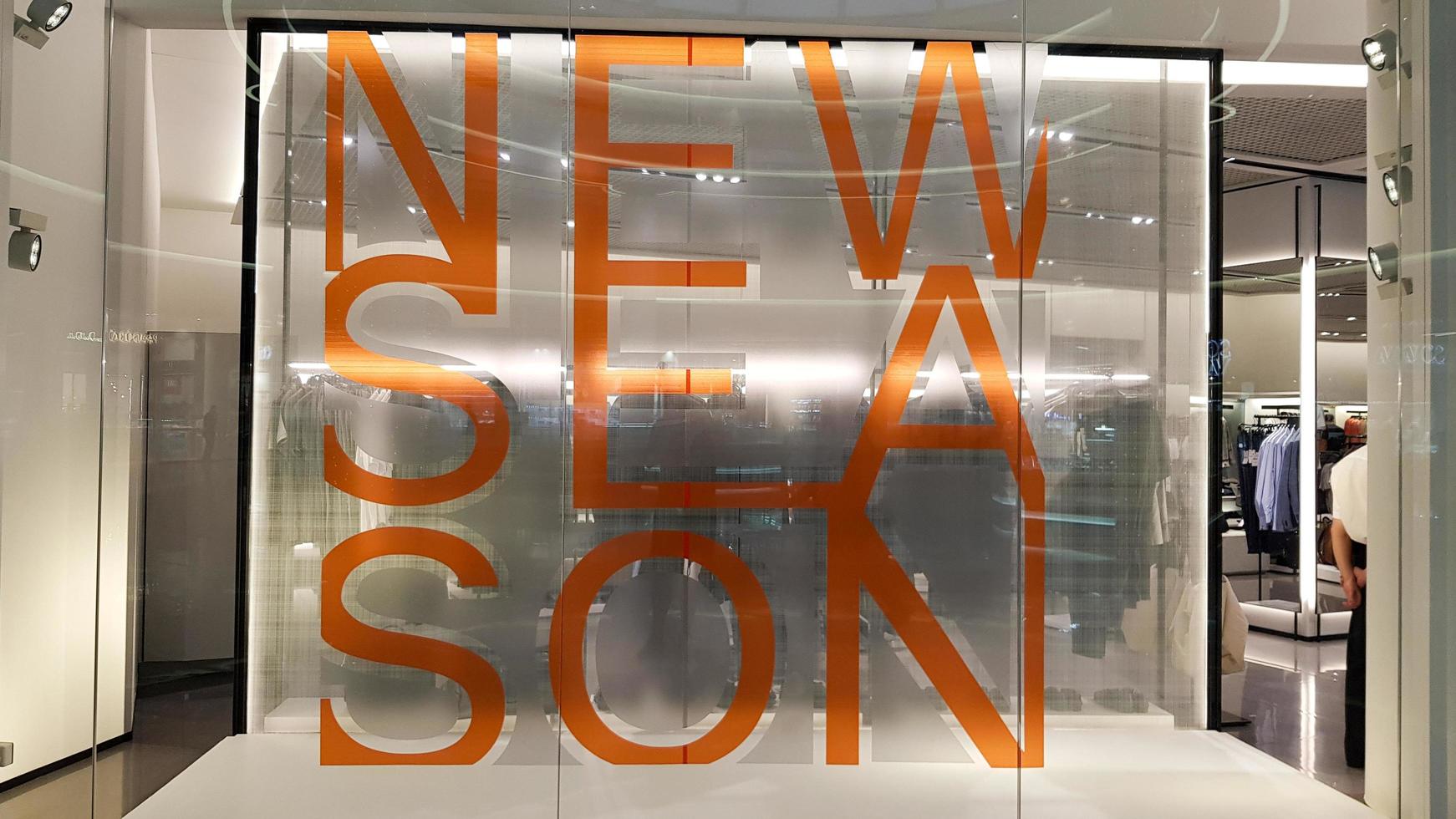 Ukraine, Kiev - September 04, 2019. Buyer of a clothing store window, written a new collection in capital letters in the foreground photo