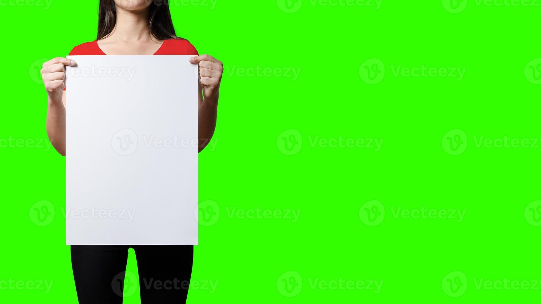 Beautiful Woman holding blank signboard on green screen background. suitable your element project. added copy space for text. photo