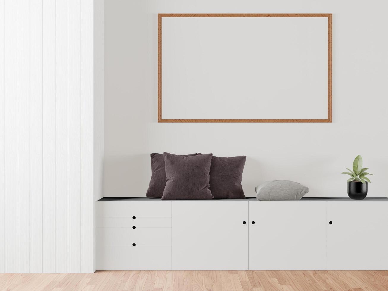 The living room is decorated with a storage table, picture frames and small plant pots. photo