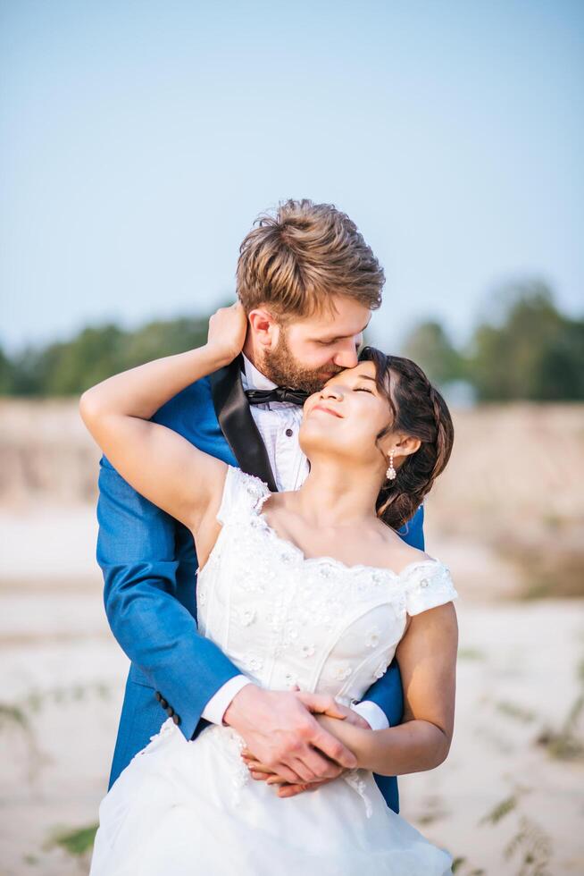 Asian bride and Caucasian groom have romance time and happy together photo