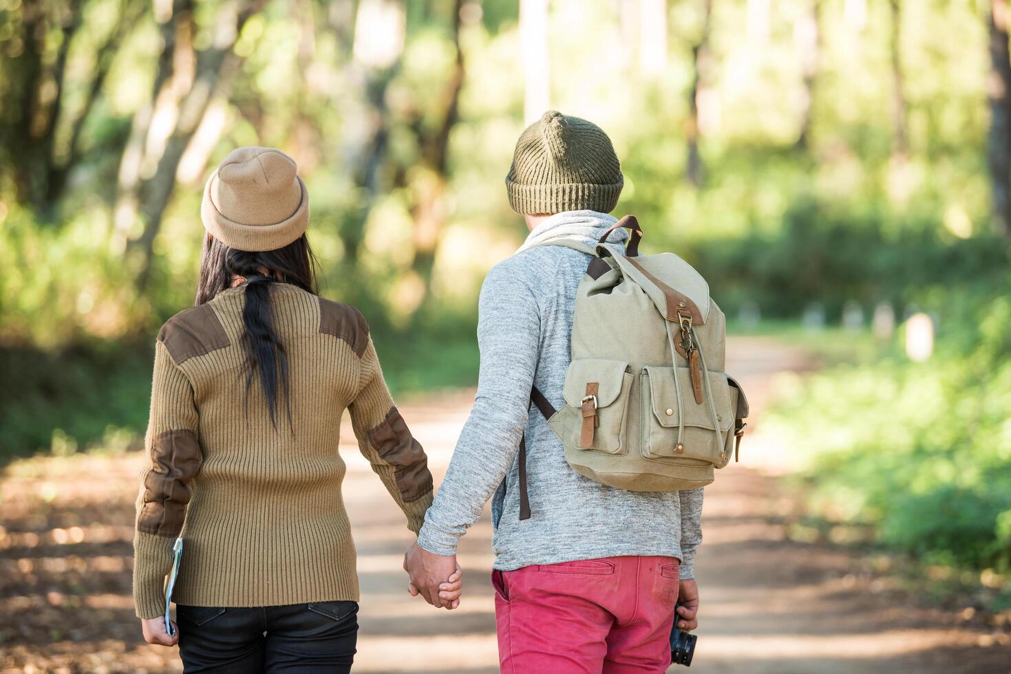 Young couple tourist travel in mountain forest photo