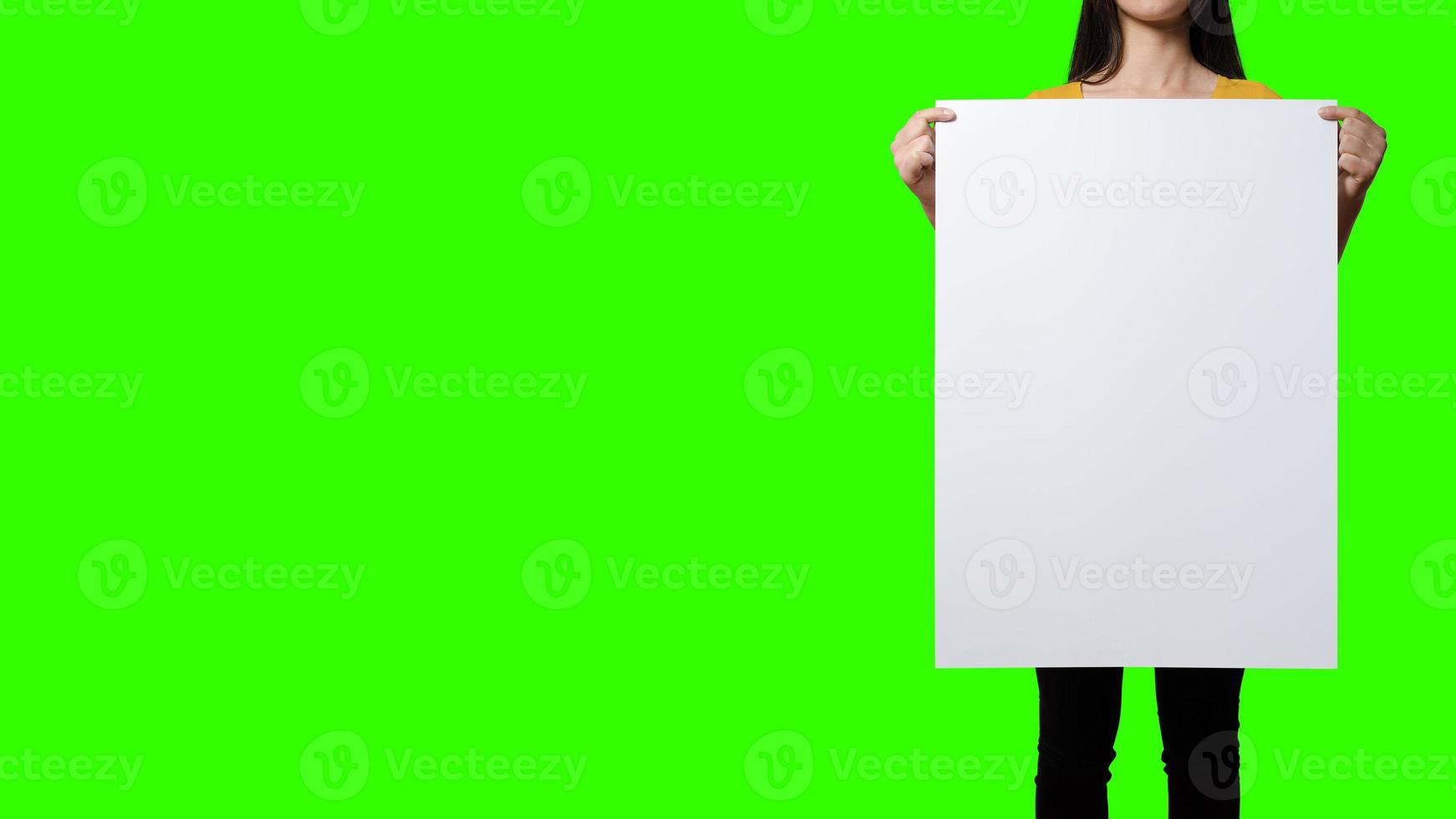 Beautiful Woman holding blank signboard on green screen background. suitable your element project. added copy space for text. photo