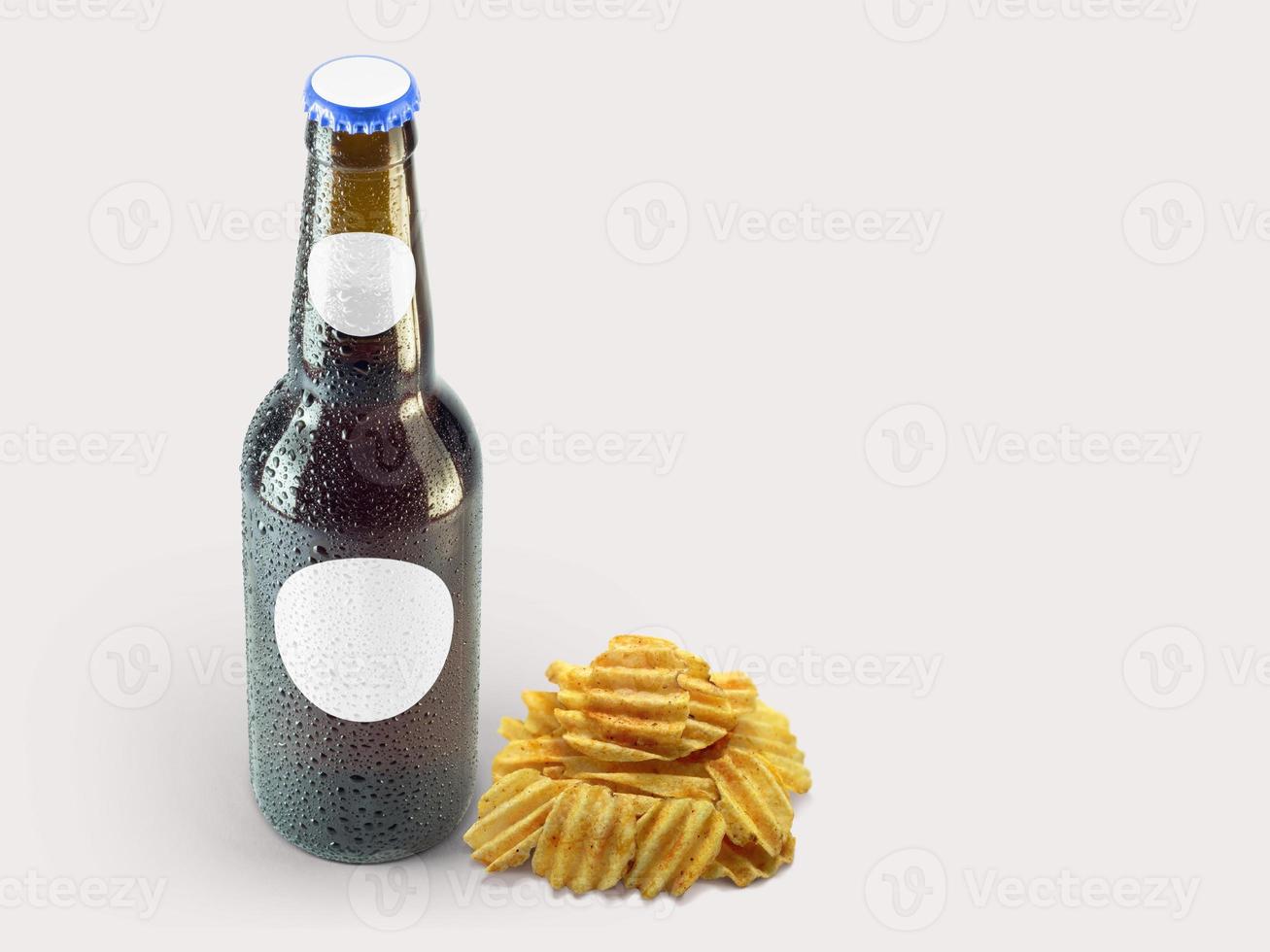 Potatoes chip snacks and brown bottle isolated on colored background. oktoberfest concept. photo