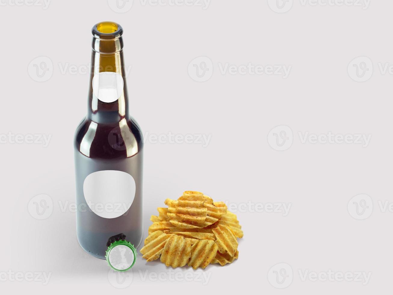 Potatoes chip snacks and brown bottle isolated on colored background. oktoberfest concept. photo