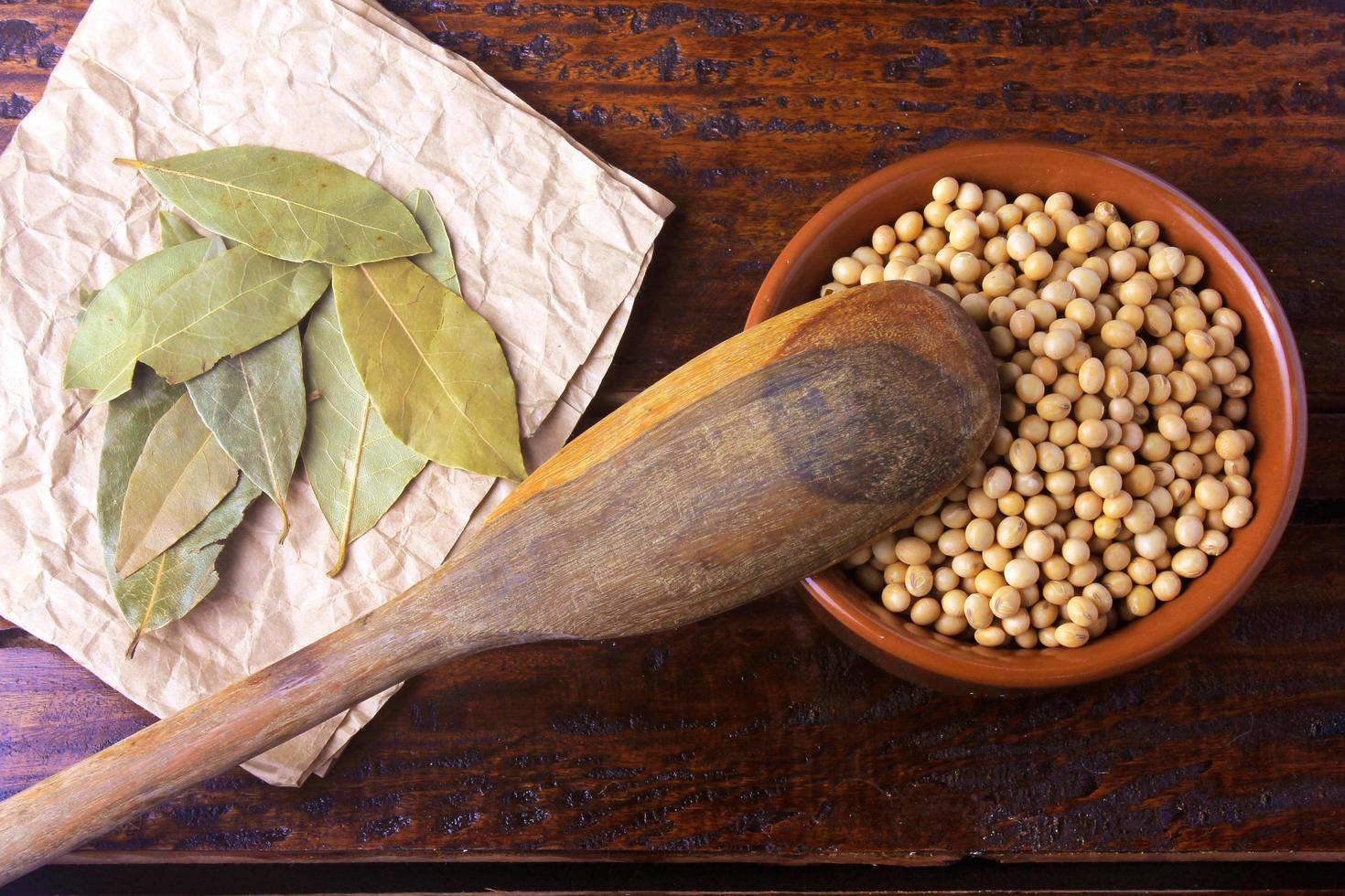 raw and fresh soy beans inside white ceramic bowl on rustic wooden table. Close up photo