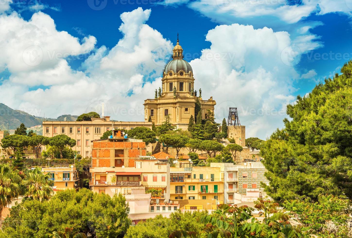 Cityscape of Messina with Cathedral on the top of the hill, colored houses and beautiful clouds with a blue sky, Sicily, Italy photo