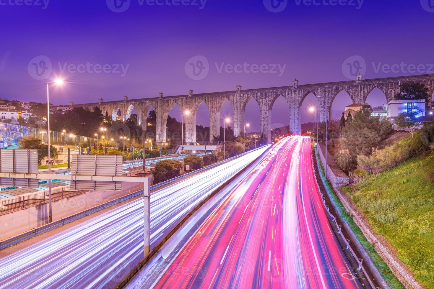 View of highway with car traffic and light trails. The Aguas Livres Aqueduct Aqueduto das Aguas Livres in Lisbon, Portugal photo