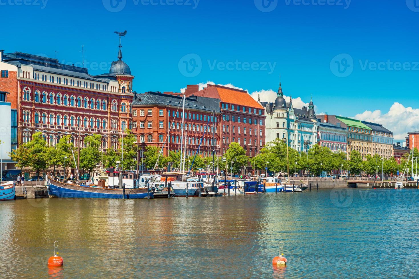 Beautiful cityscape of Helsinki with the traditional architecture, wharf with boats and clear blue sky on the background, Finland photo
