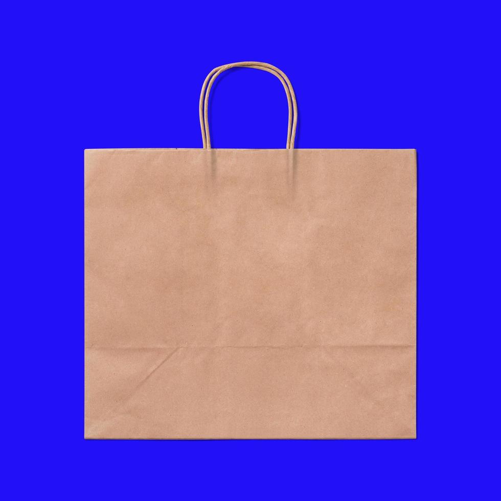 Luxury recycled paper shopping bag isolated on blue background. photo