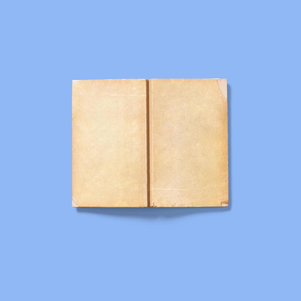 Soft book cover upside down open , isolated on blue background. vintage concept. photo