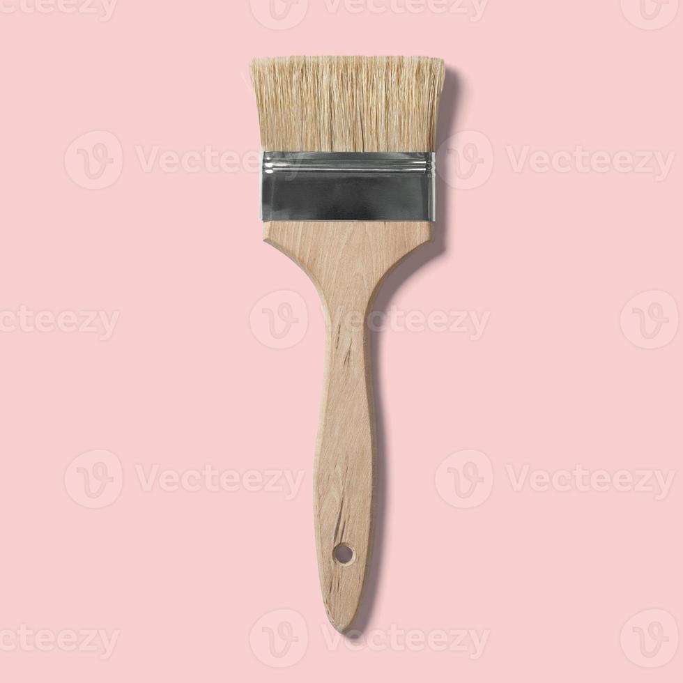 Isolated paint brush for painting on a pink background. suitable for your design element. photo