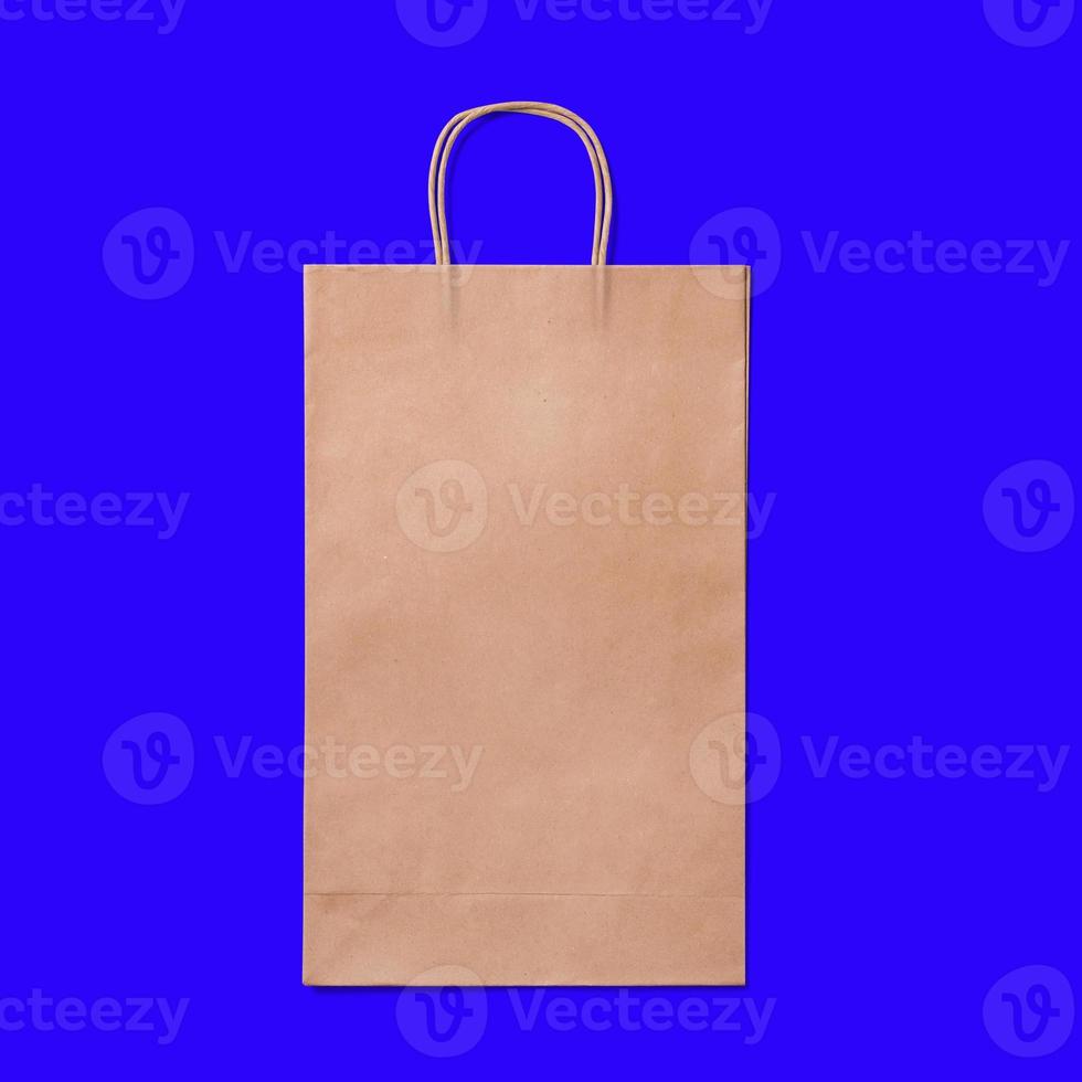 Luxury recycled paper shopping bag isolated on blue background. photo