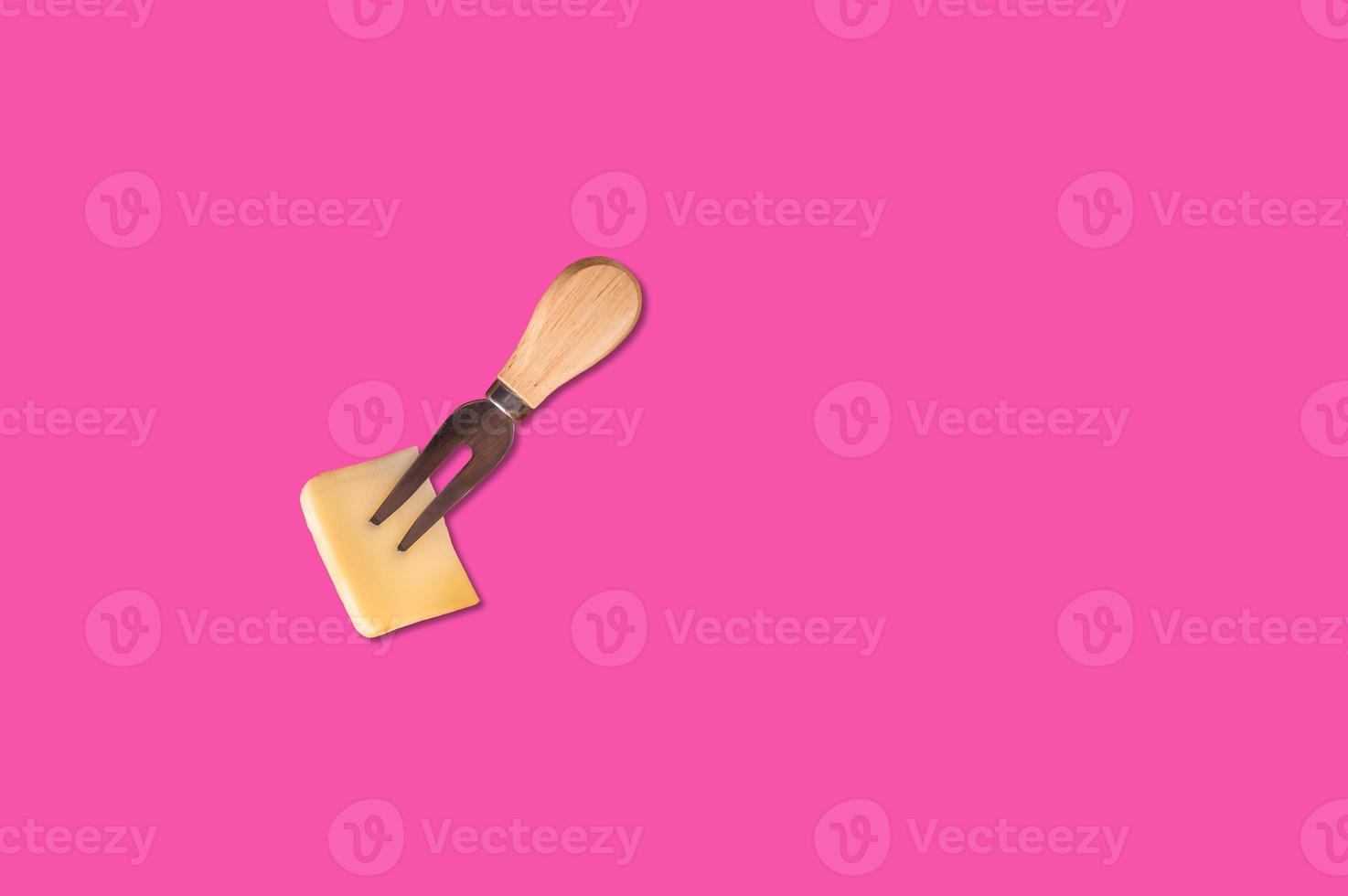 Cheese piece in Creative conceptual top view flat lay composition with copy space isolated on pink background in minimal style photo