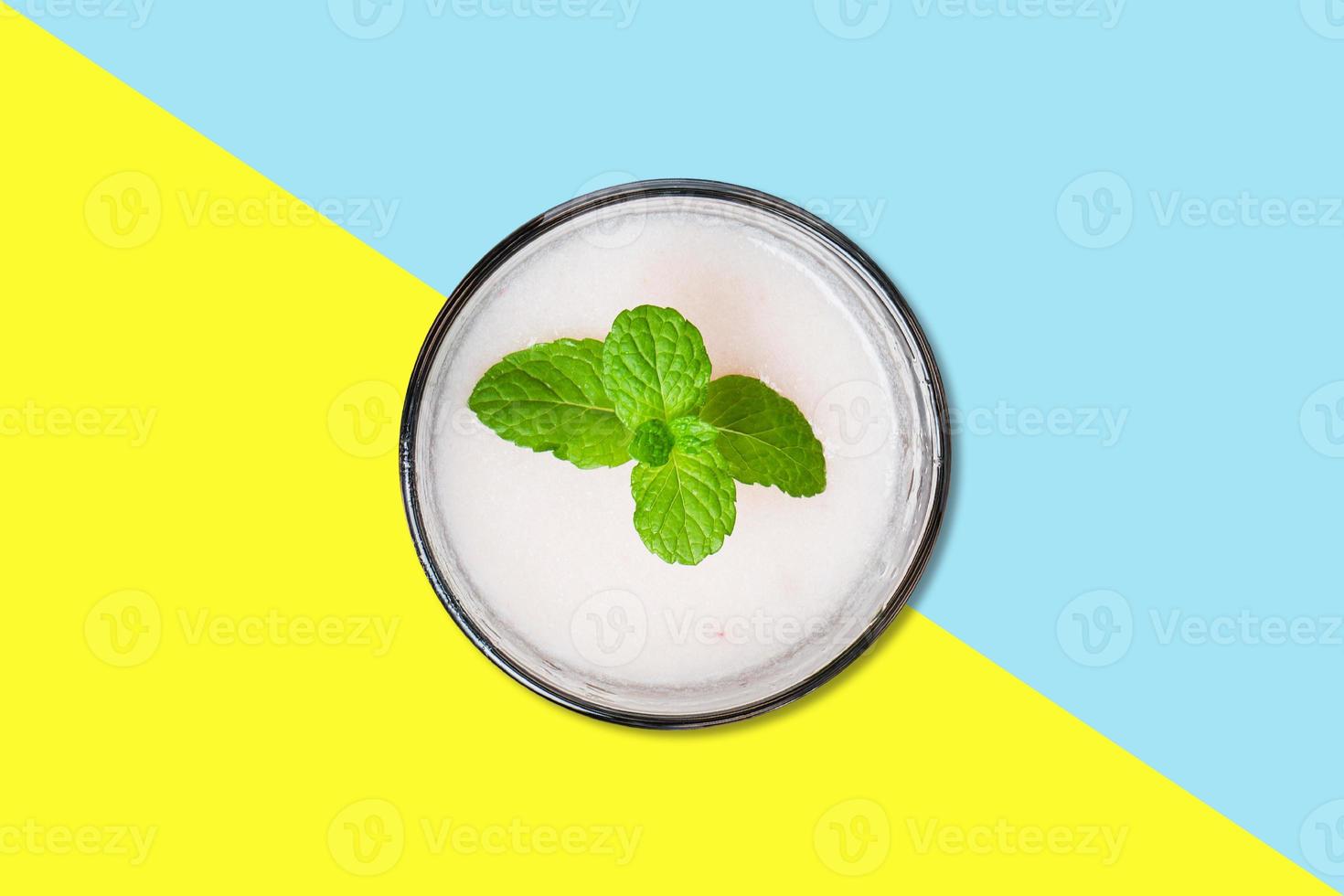 Vanilla juice on small cup with mint leaf flat lay concept isolated. photo