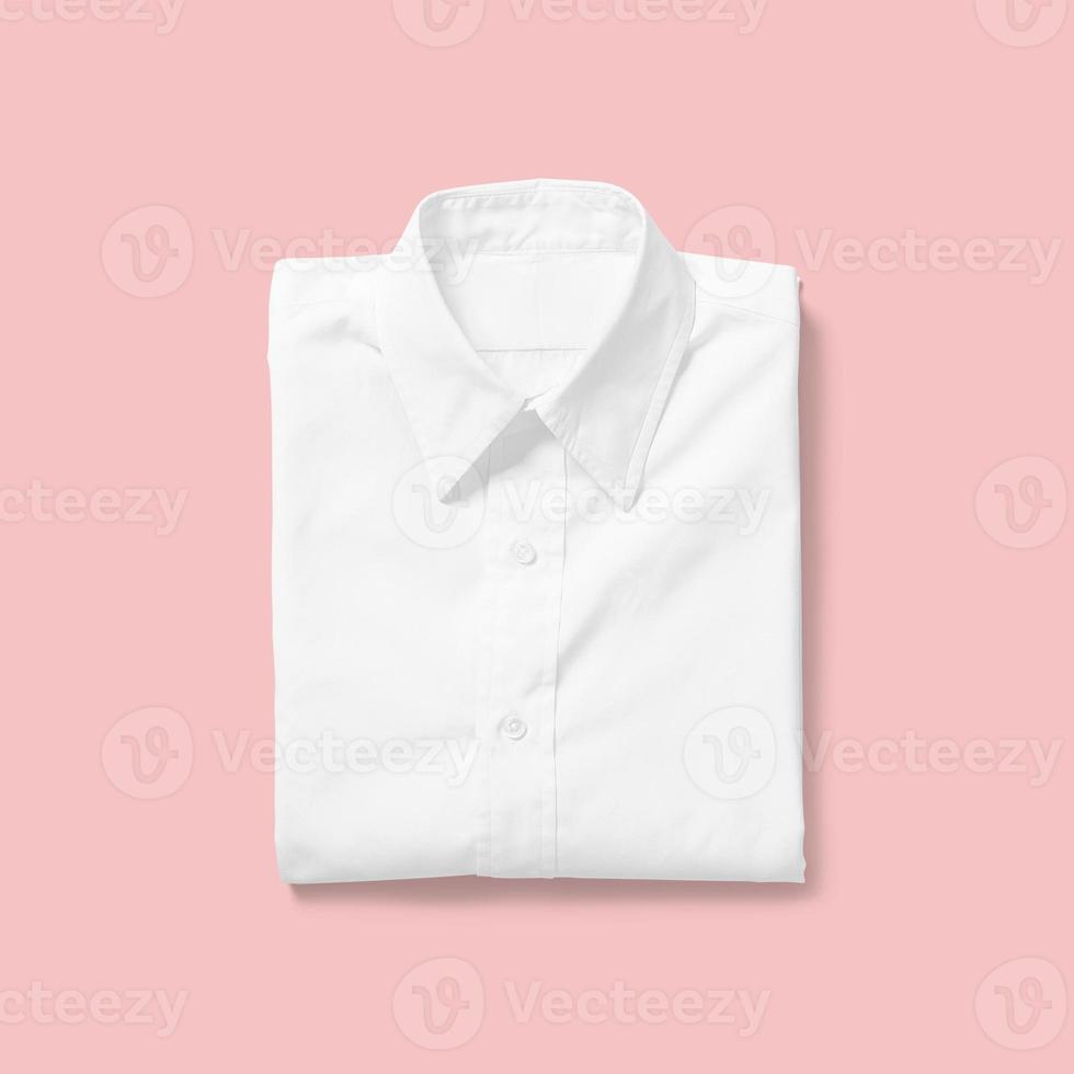 Top up up view white shirt folded isolated on pink background. suitable for your design project. photo