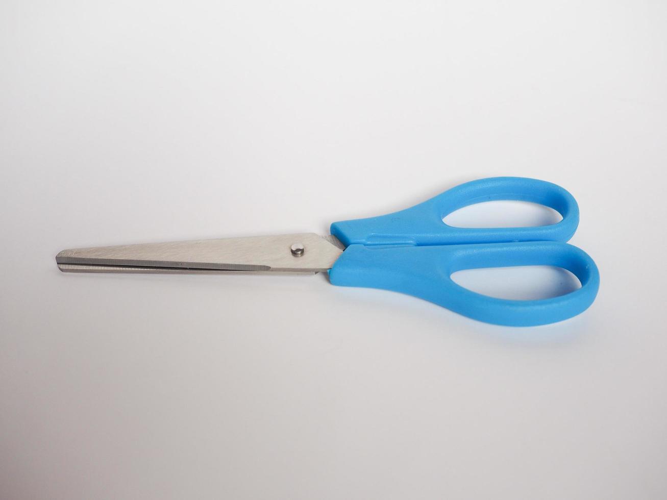 Blue scissors on desk photo