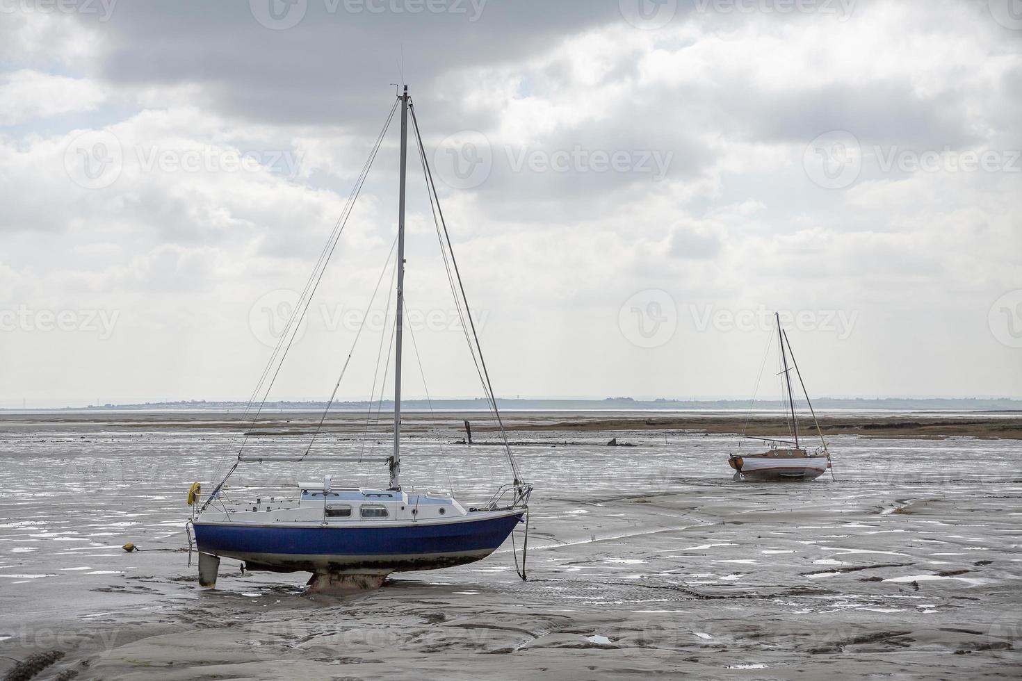 Fisherman boats stuck on the beach in low tide period. photo