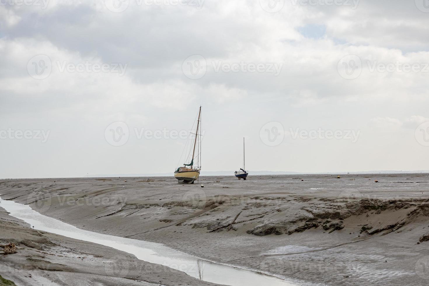 Barcos de pescadores atrapados en la playa en período de marea baja. foto