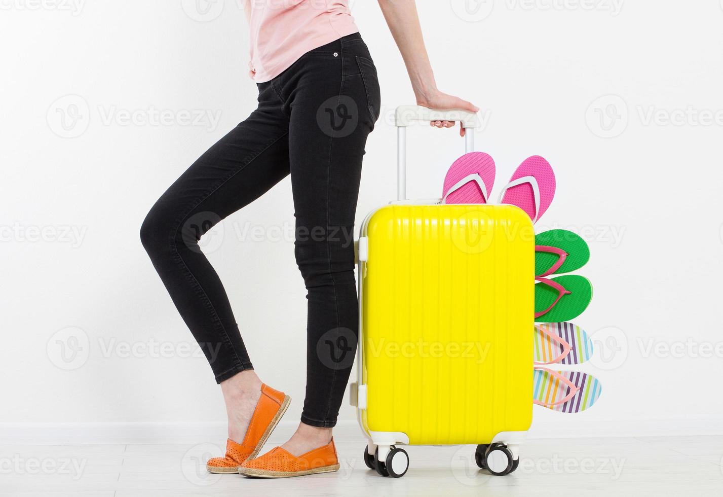 girl with suitcase isolated on white background .Summer holidays. summer flip flops or slippers. Travel valise or bag. Mock up. Copy space. Template. Blank. photo
