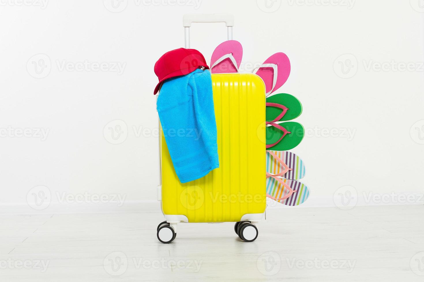 suitcase isolated on white background Summer holidays. summer flip flops or slippers.Sandals beach.Red cap.Travel valise or bag. Mock up. Copy space. Template. Blank. photo
