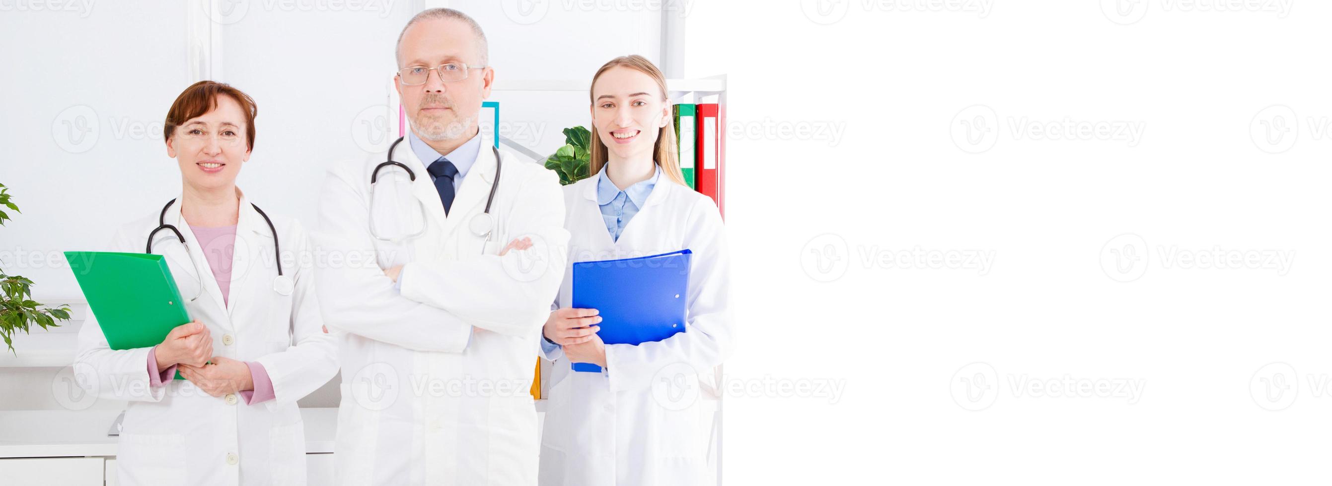 doctor posing with medical staff,nurse in office and copy space, banner of billboard photo
