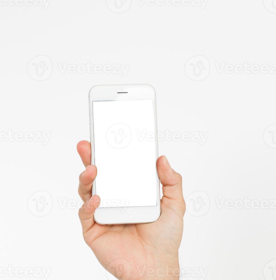 Hand holding white phone isolated on white clipping path inside. Top view.Mock up.Copy space.Template.Blank. photo