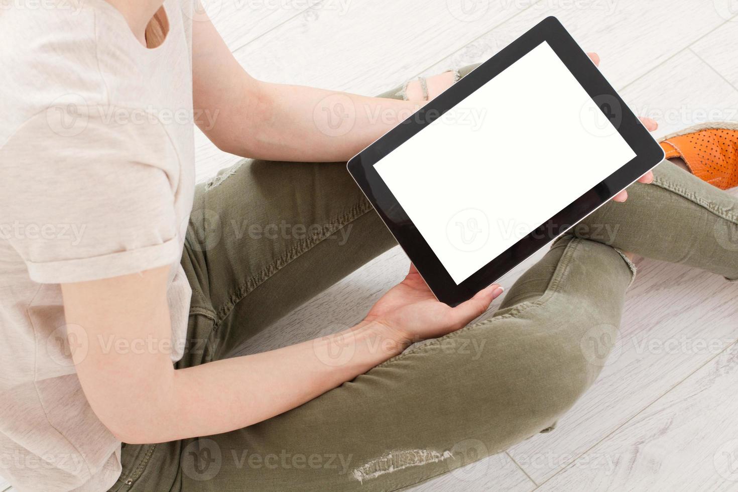 Girl sitting with tablet in hands. Online shopping.Top view.Mock up.Copy space.Template.Blank. photo