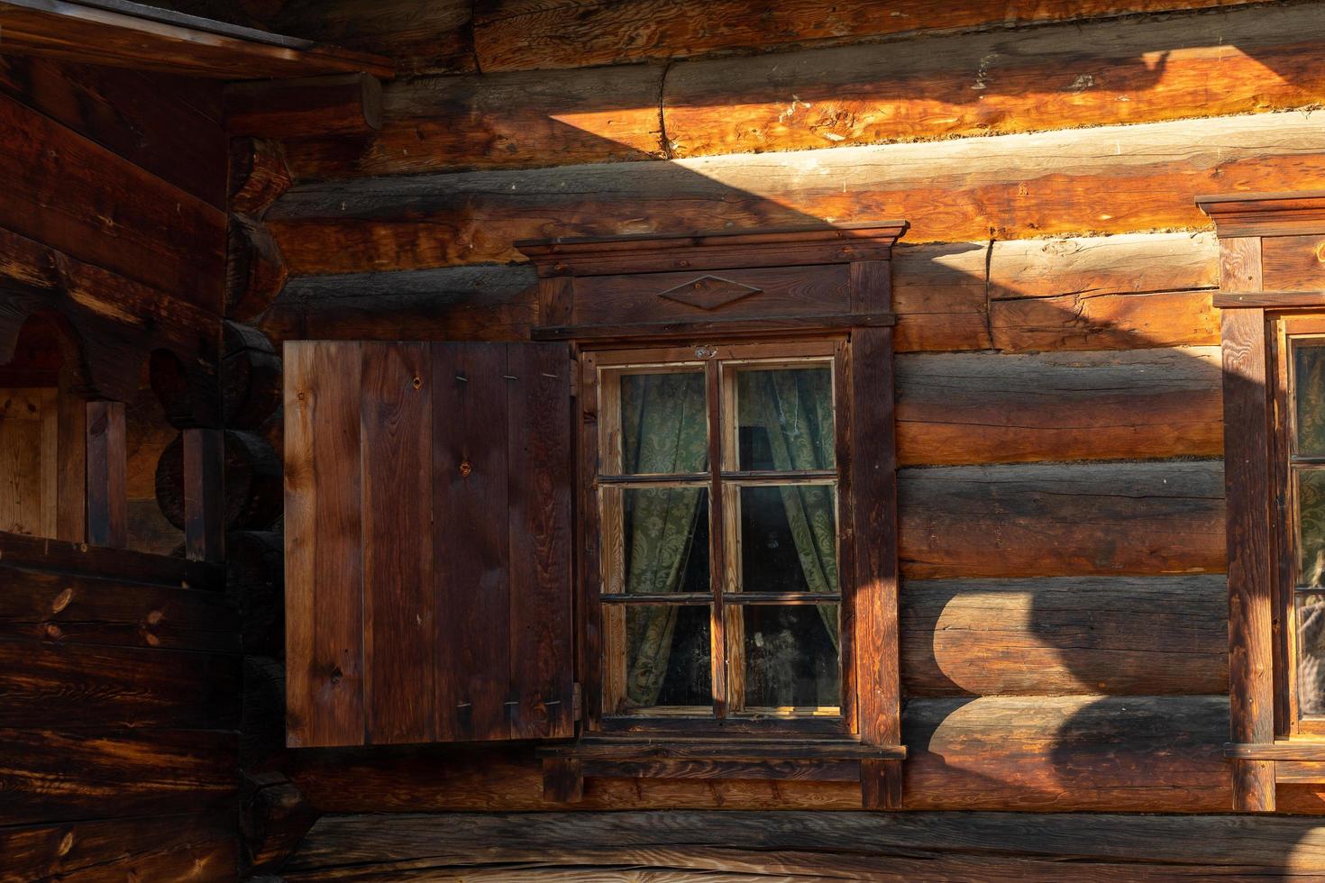 Facade of a wooden building with a window. photo