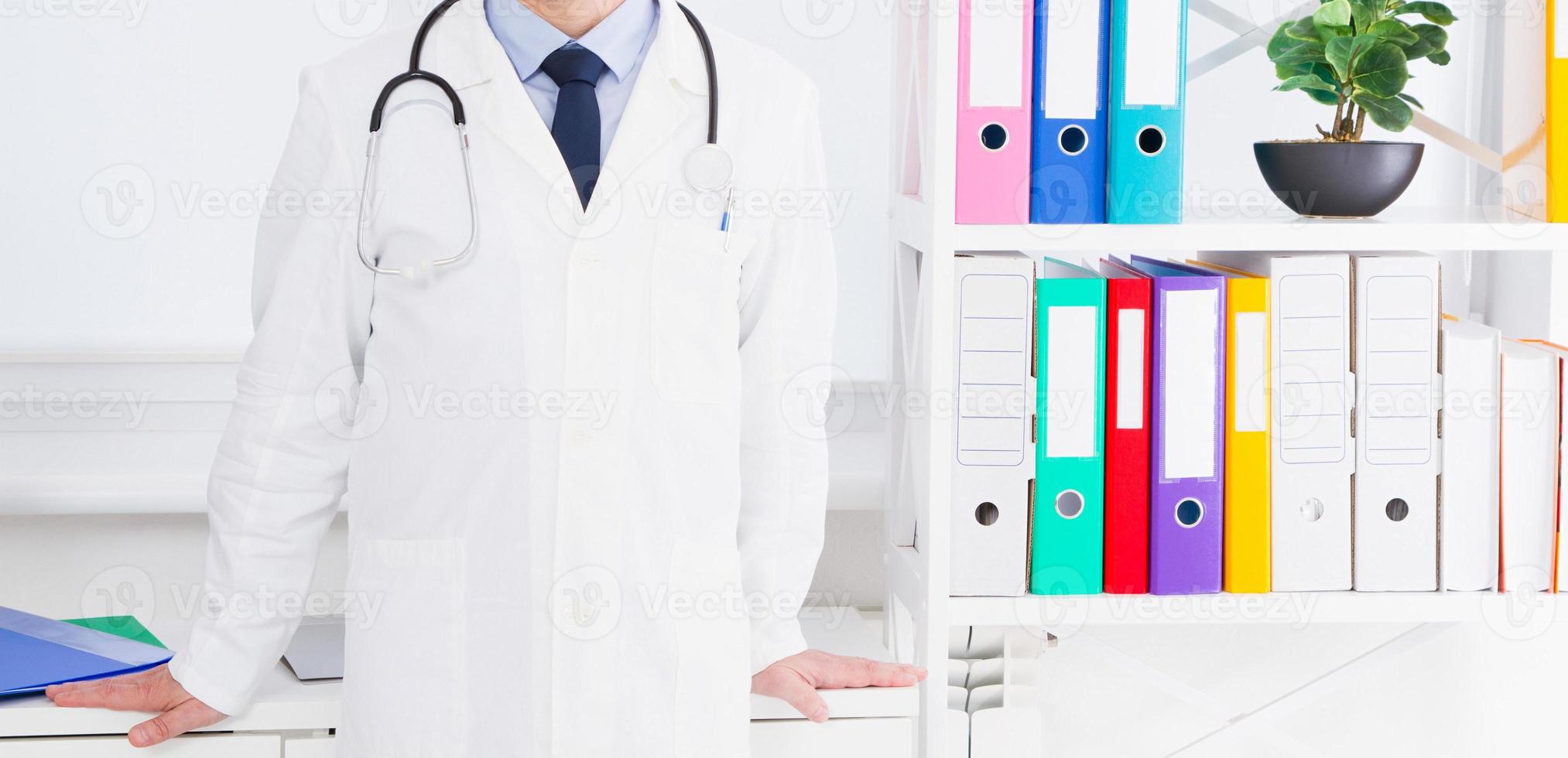 Portrait of senior doctor in medical office photo