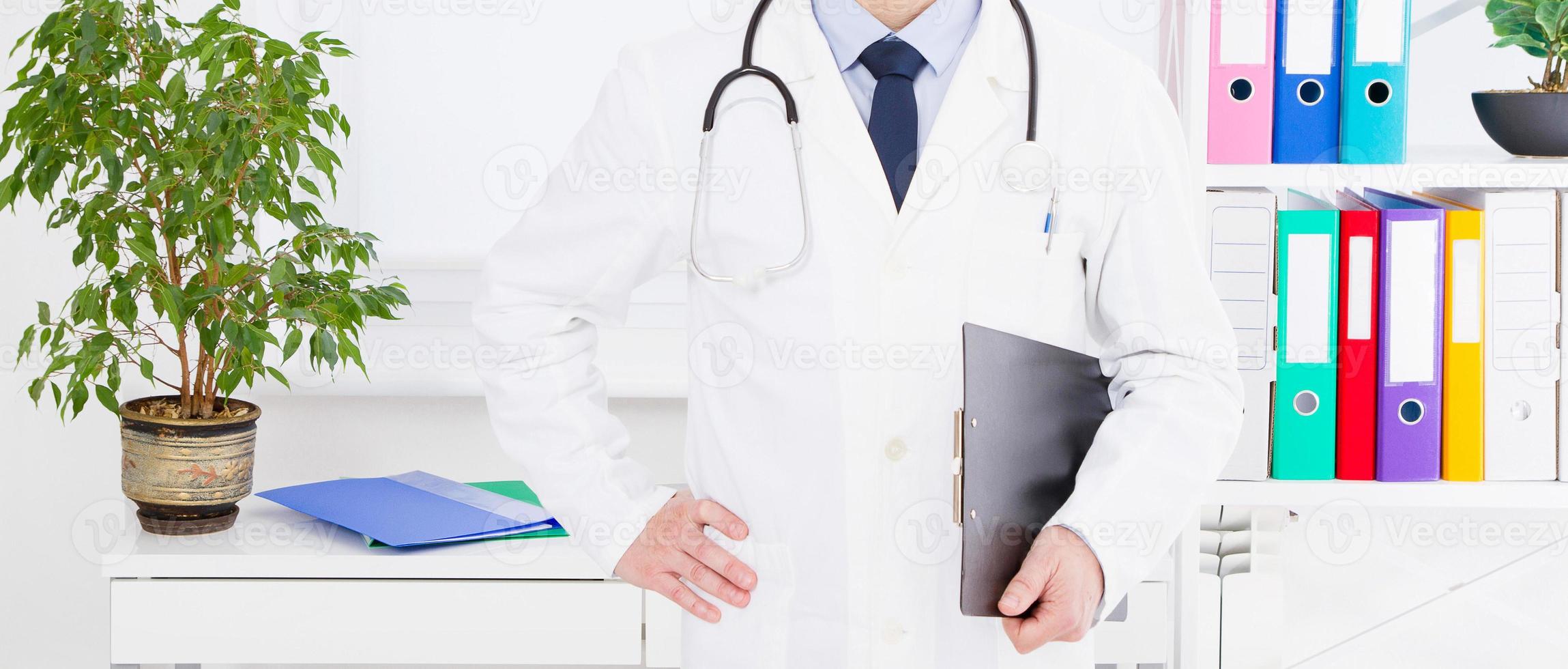 Portrait of senior doctor in medical office photo