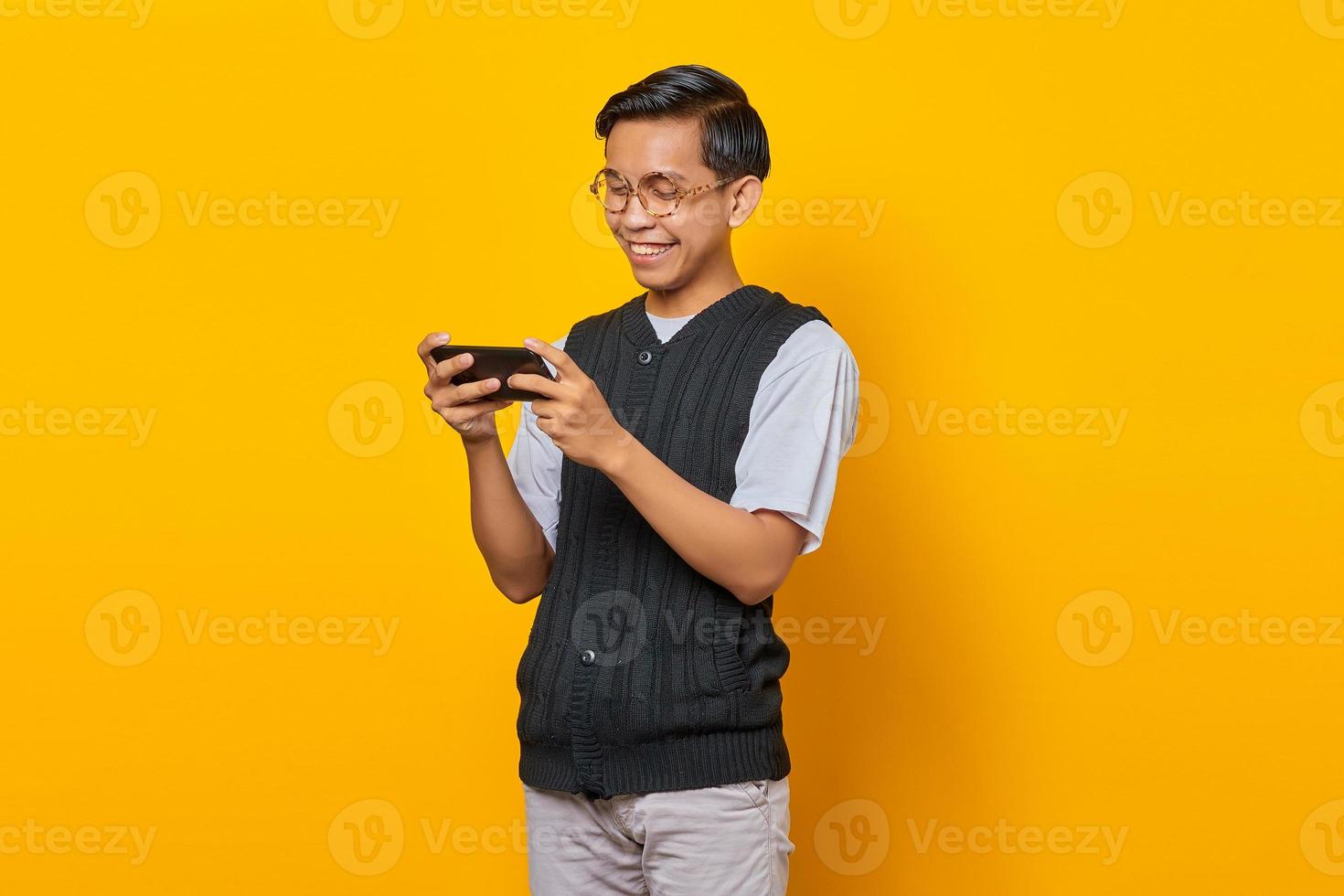 Asian Man Is Playing Mobile Game Seriously. Stock Photo, Picture