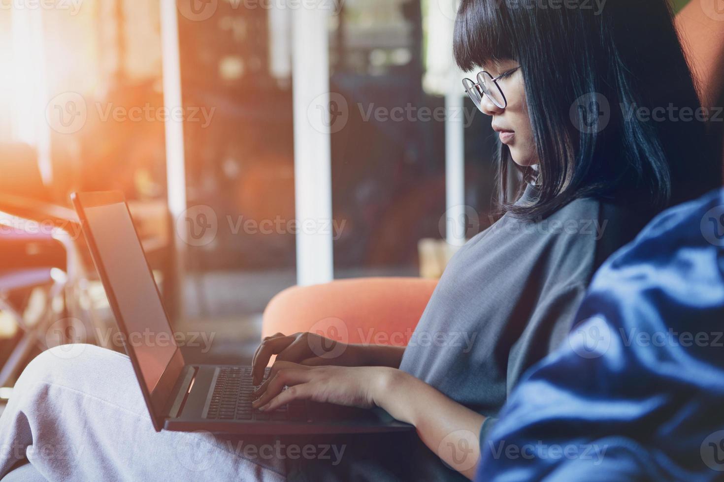 asian teenager studying online at home while outbreaking of covid-19 photo