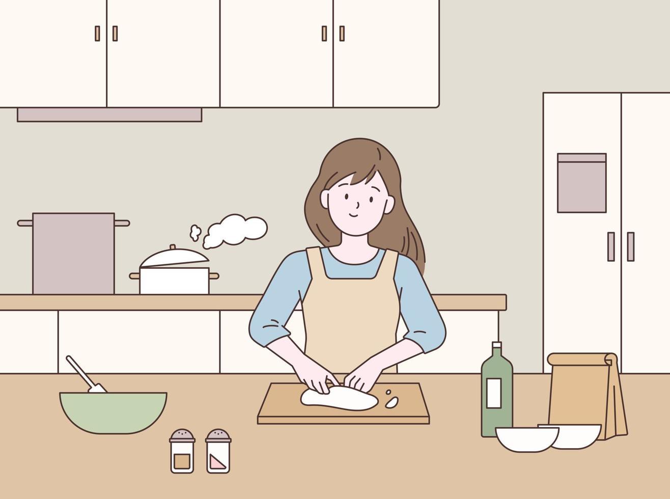 A woman is cooking in the kitchen. vector
