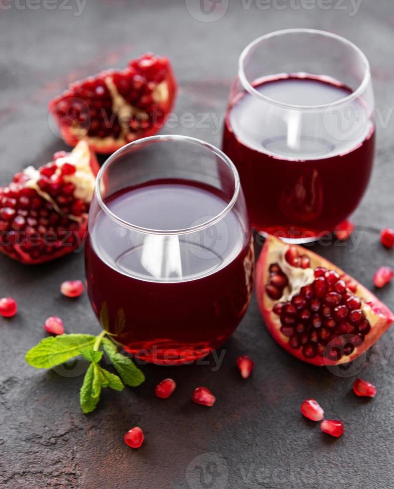 Pomegranate juice with fresh pomegranate fruits photo