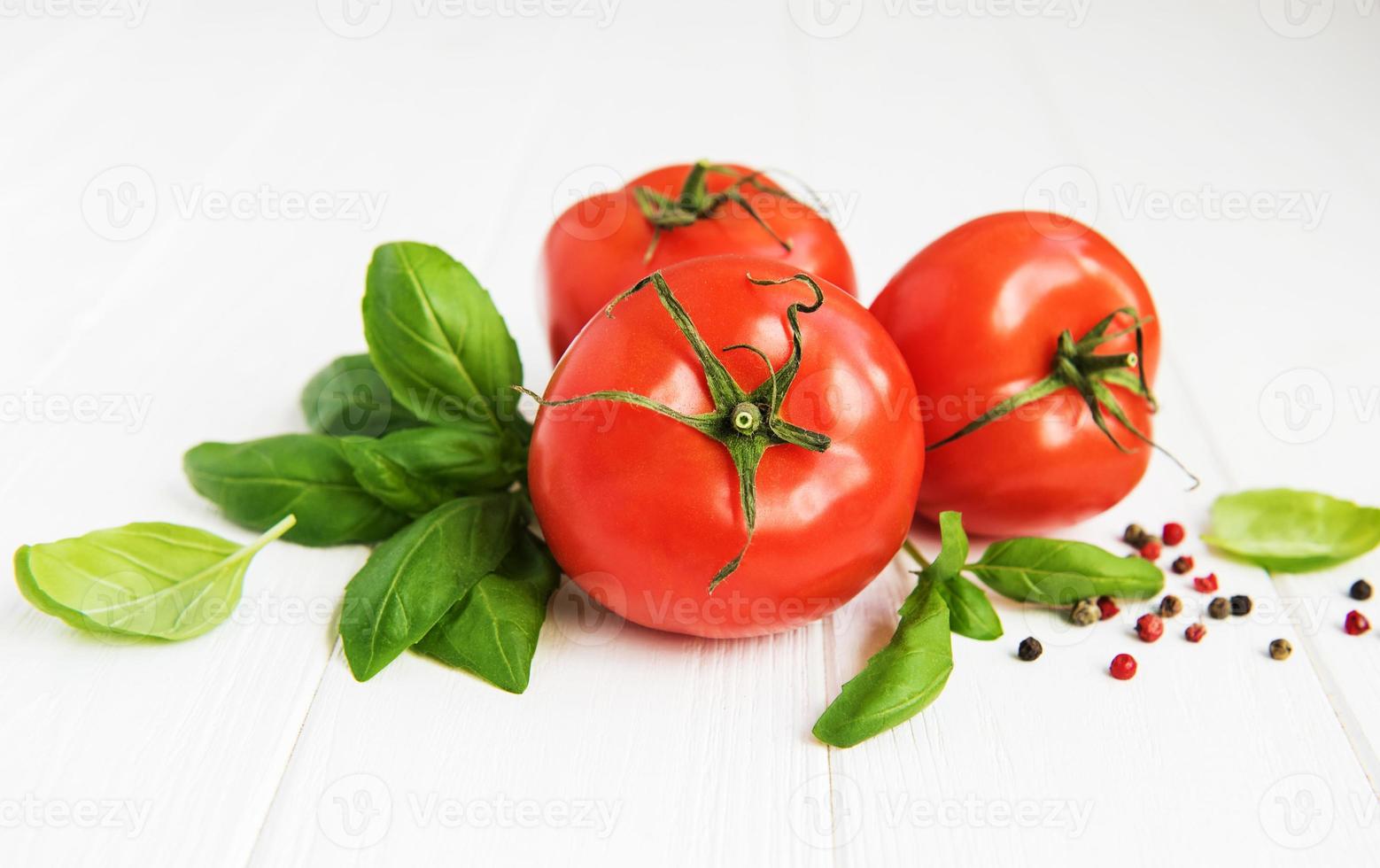 Fresh tomatoes with green basil photo